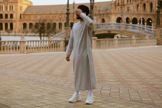 Man in een lichtgrijze qamis op de Plaza de España in Sevilla